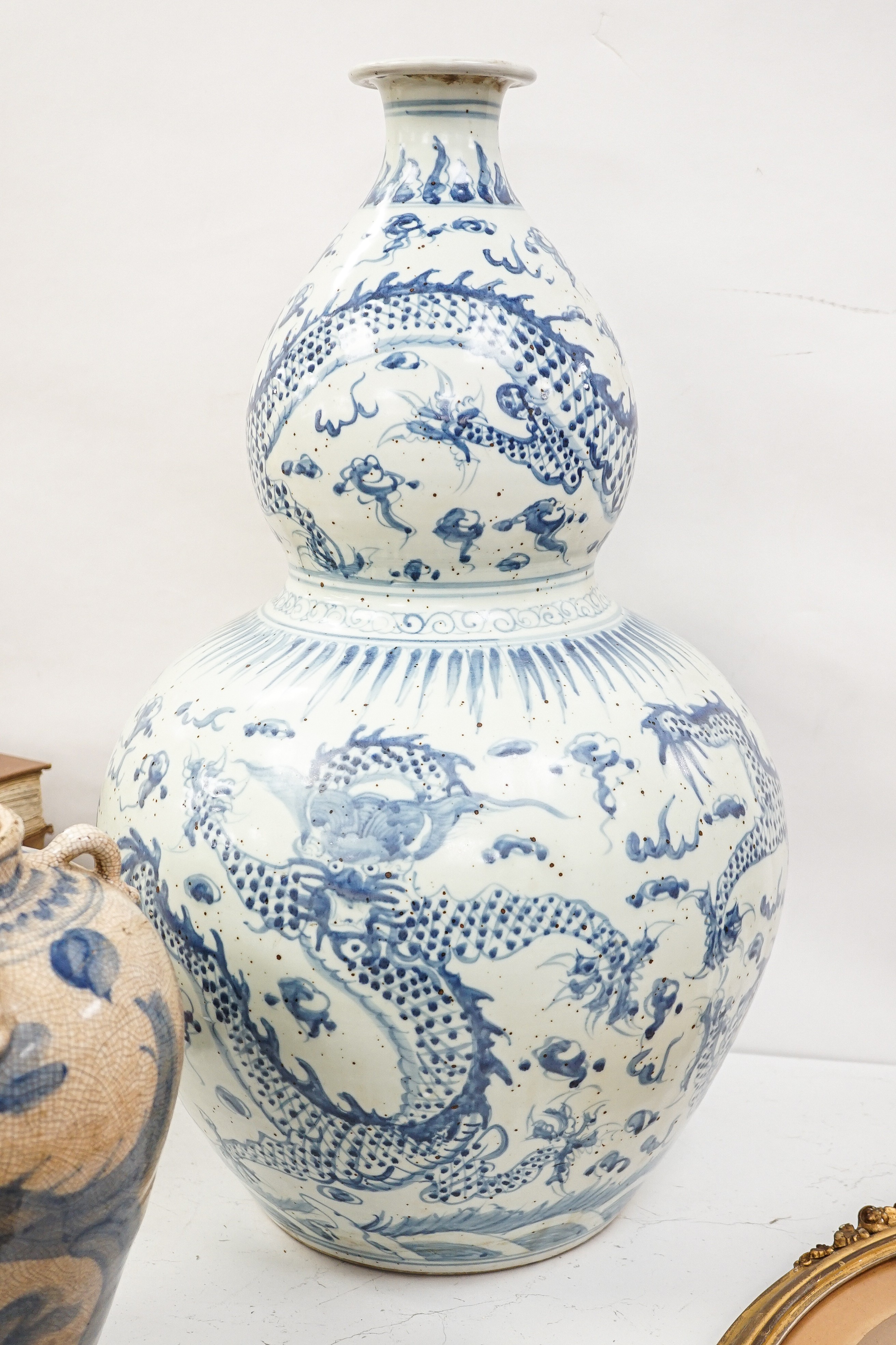A large Chinese blue and white 'dragon' double gourd vase, 64cm high and an Annamesse style blue and white crackle glaze jar